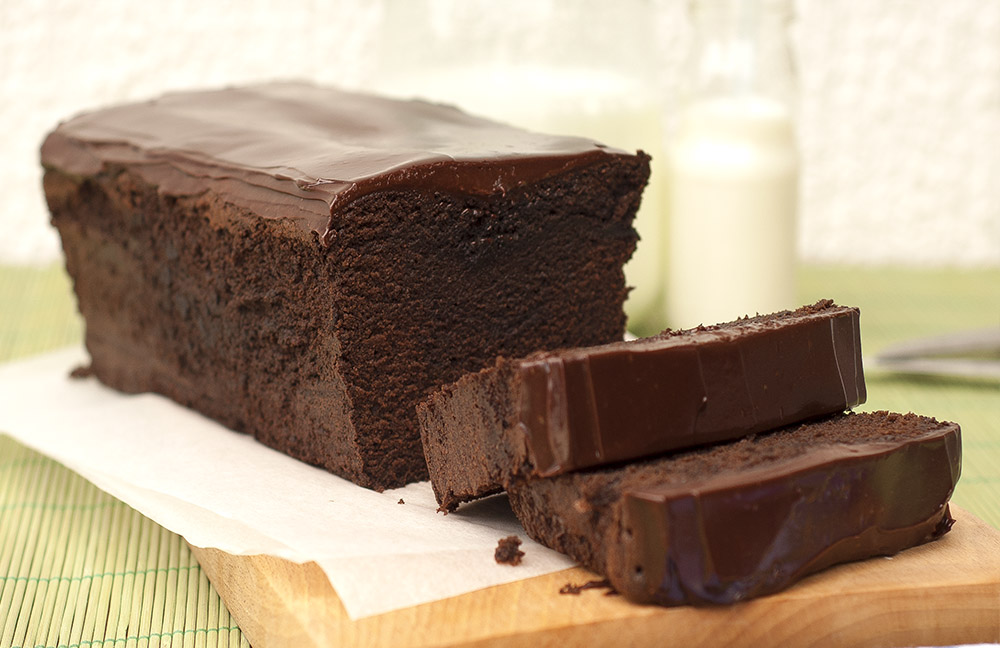 Chocolate Pound Confection recipe with Chocolate Ganache on a white parchment paper.