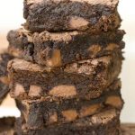 Stack of fudgey brownies with chocolate chunks