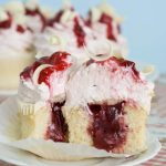 White chocolate strawberry cupcake filled with jam, sliced in half