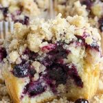 Bitten blueberry muffin with streusel crumbs on top
