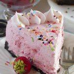 Slice of No Bake Strawberry Cheesecake on white plate.