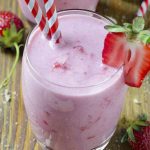Glass of strawberry shortcake smoothie with fresh strawberries