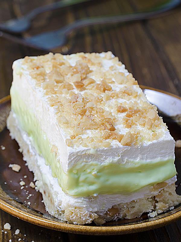Big piece of Key Lime Pie Lasagna on a brown plate.