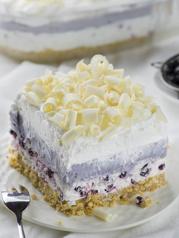 A piece of Blueberry Lasagna served on white plate.