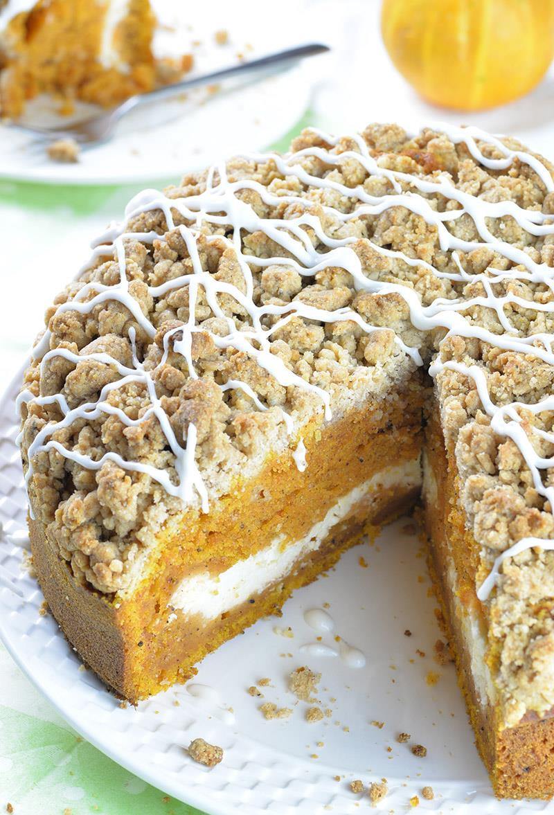 This is the fall recipe you’ve all been waiting for- Pumpkin Coffee Cake!!! A big slice of spiced pumpkin cake with cream cheese filling in the center and crunchy brown sugar-cinnamon crumbs on top.