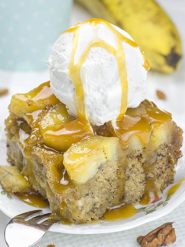 Piece of Banana Upside Down Cake with ice cream on top.