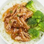 Plate of teriyaki chicken served over rice with broccoli