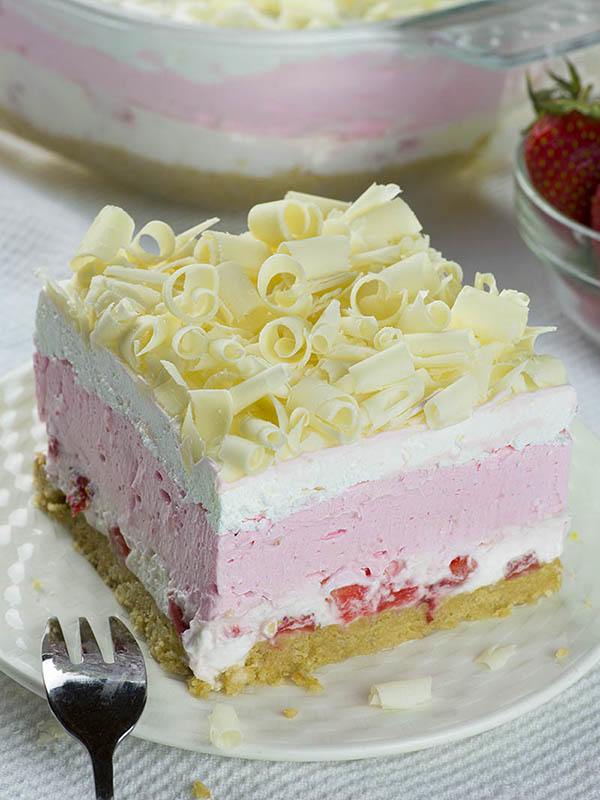 No Bake Strawberry Jello Lasagna slice in white plate!