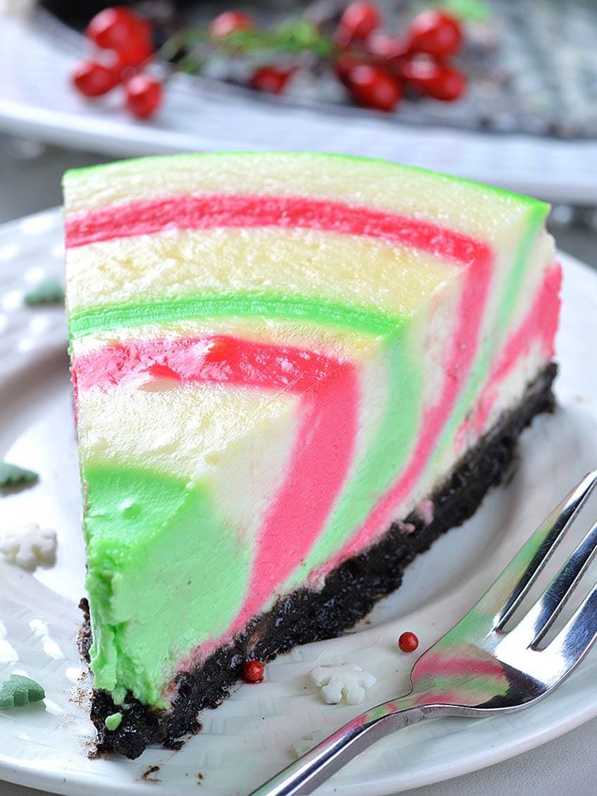 Colorful piece of Christmas cheesecake in a plate.