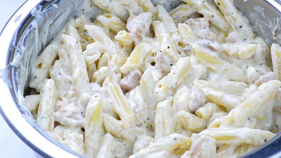 Mixed chicken, pasta and Alfredo sauce into one mix.