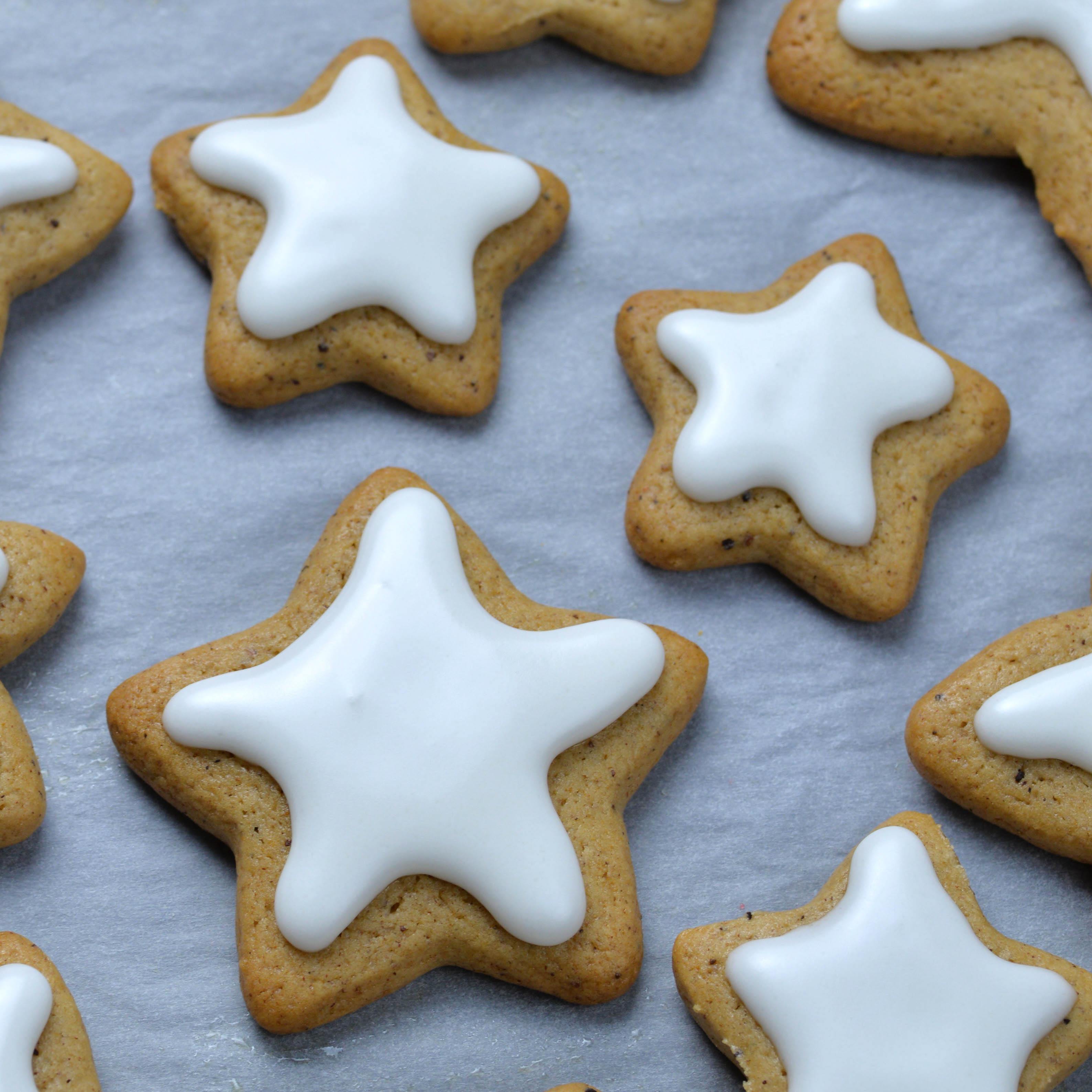 Baked star-shaped gingerbread cookies powdered with sugar for