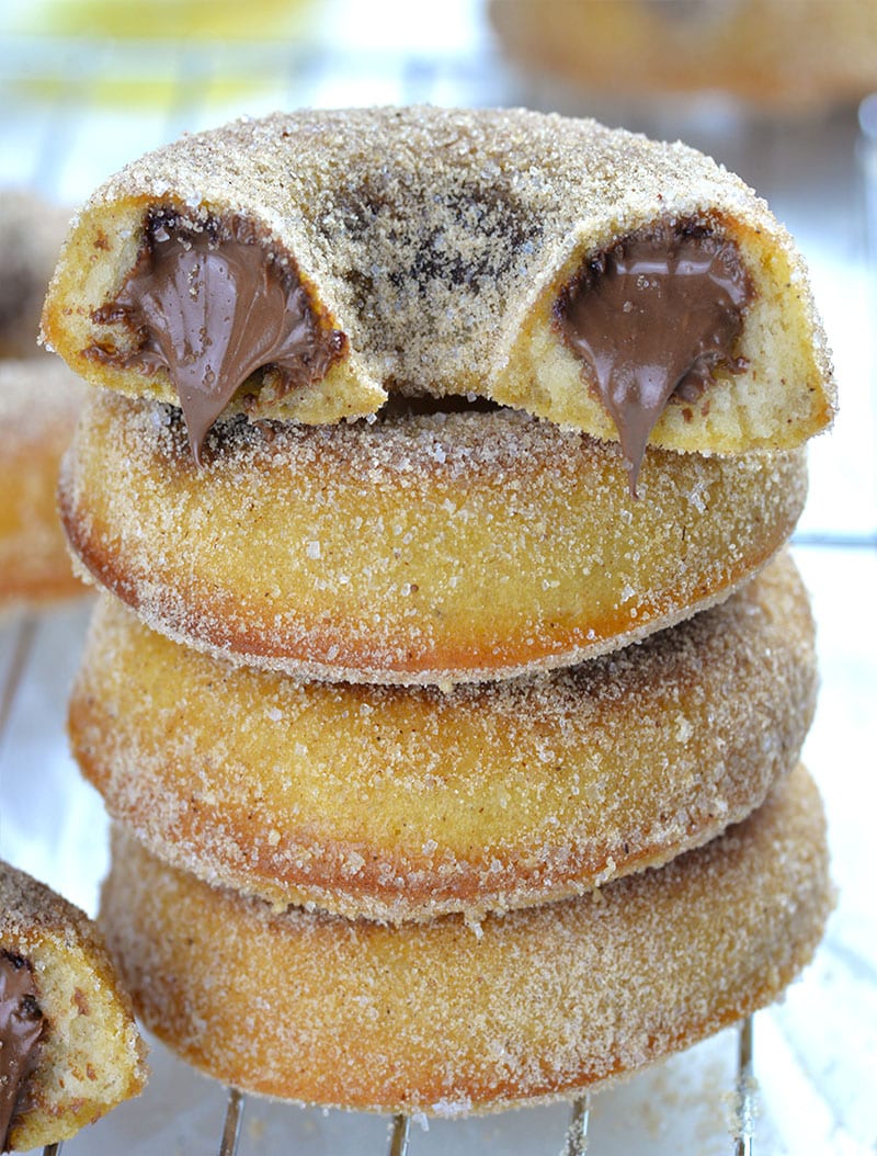Three Nutella Filled Baked Donuts and one half of donut on the top.