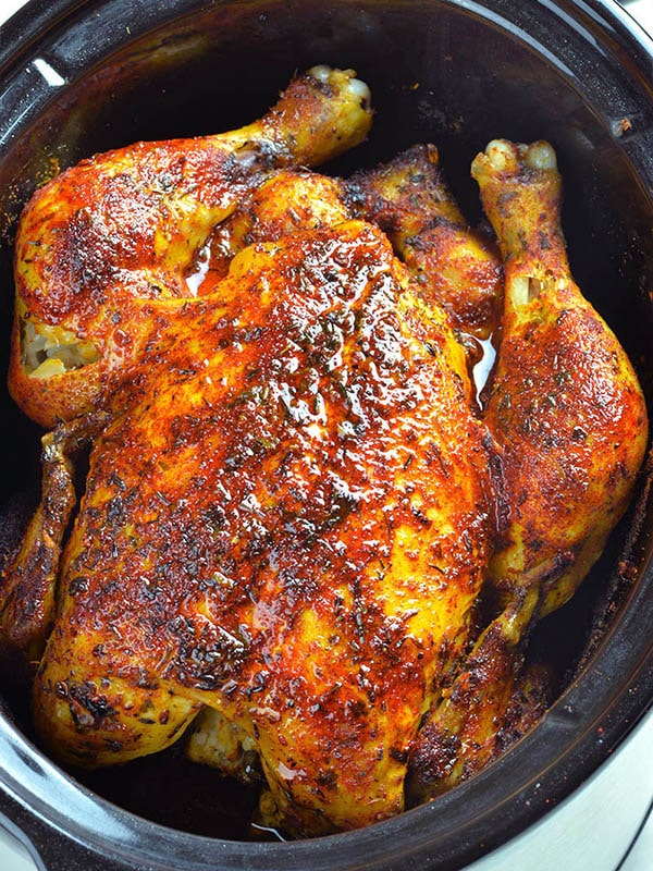 Whole chicken cooked in a slow cooker.