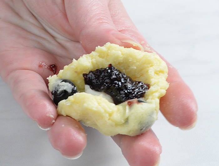 Cookie dough with cream cheese and blueberry jam filling.