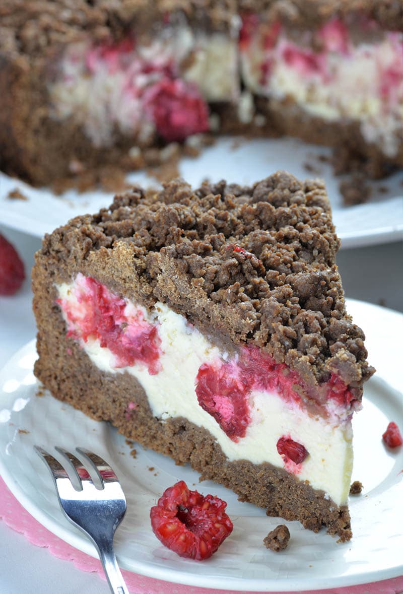 Piece of Chocolate Raspberry Cheesecake Crumb Cake on a white plate.