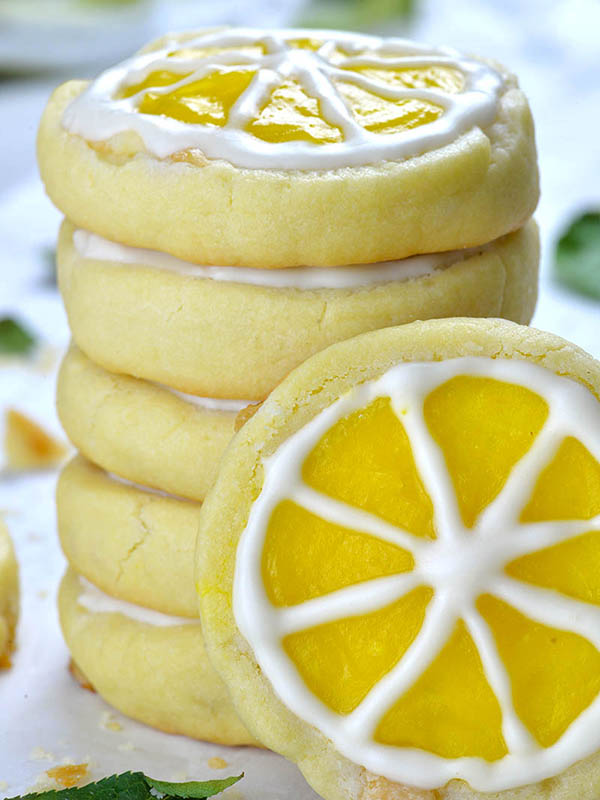 Couple of Lemon Shortbread Cookies one on another and one cookie in front of them.