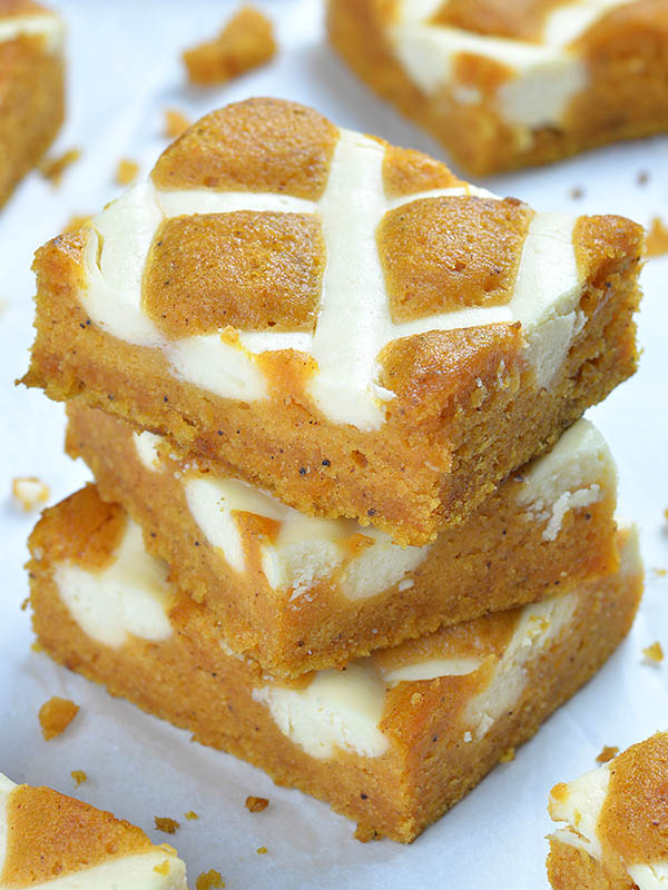 Three pieces of Pumpkin Bars with Cream Cheese stripes on the top.