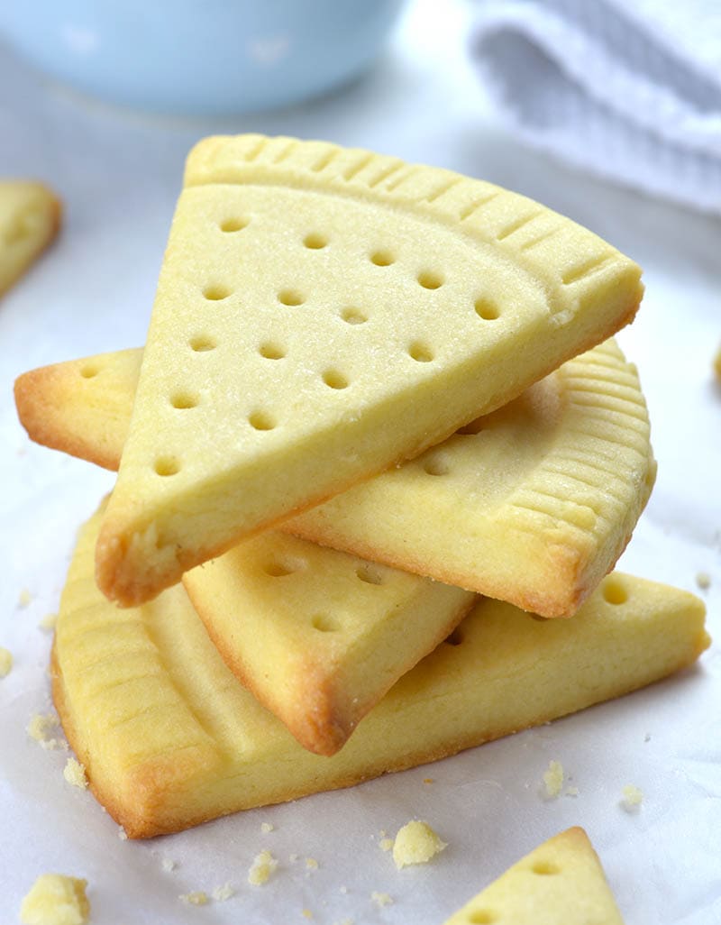 Bunch of pizza pie shaped Easy Shortbread Cookies on each others.