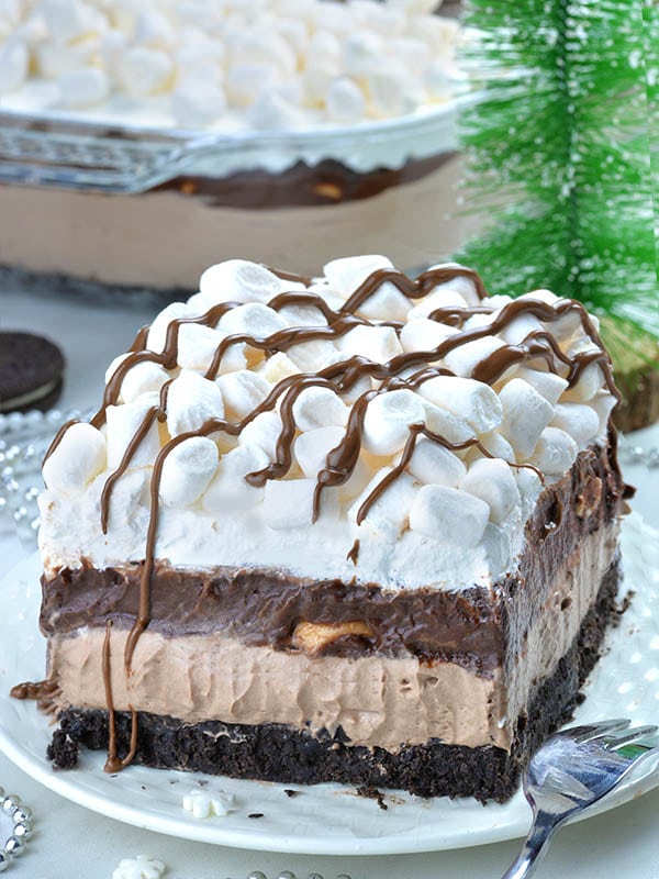 Hot Chocolate Lasagna - no bake layered dessert with Oreo crust, hot chocolate cheesecake mousse layer, chocolate pudding, whipped cream and mini marshmallows.