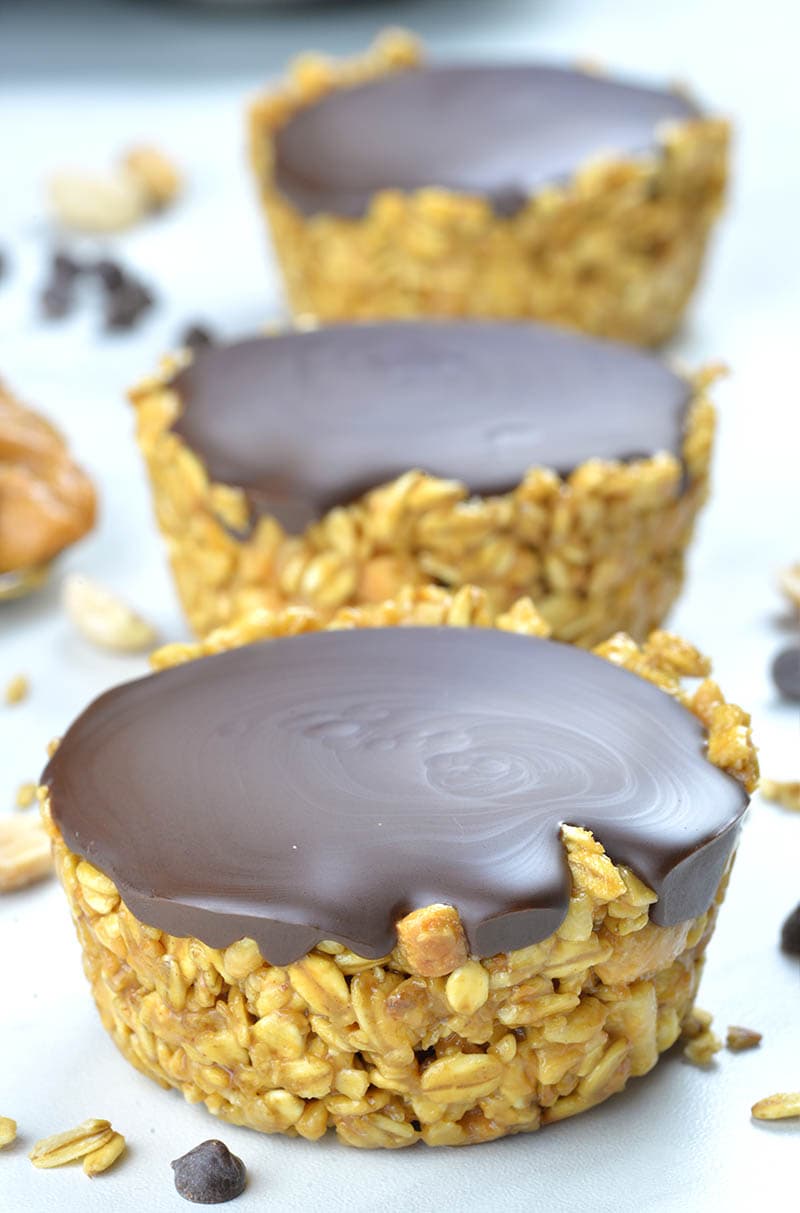 Three Healthy No Bake Peanut Butter Granola Cups on white background.