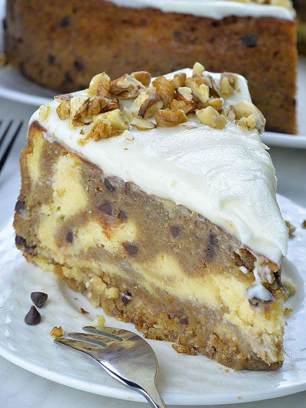 Piece of Banana Bread Cheesecake on a white plate with fork beside.