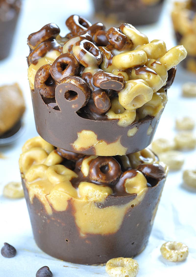 Two No Bake Chocolate Peanut Butter Cheerios Cups one on other.