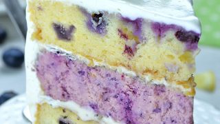 Image of a slice of Lemon Blueberry Cheesecake Cake
