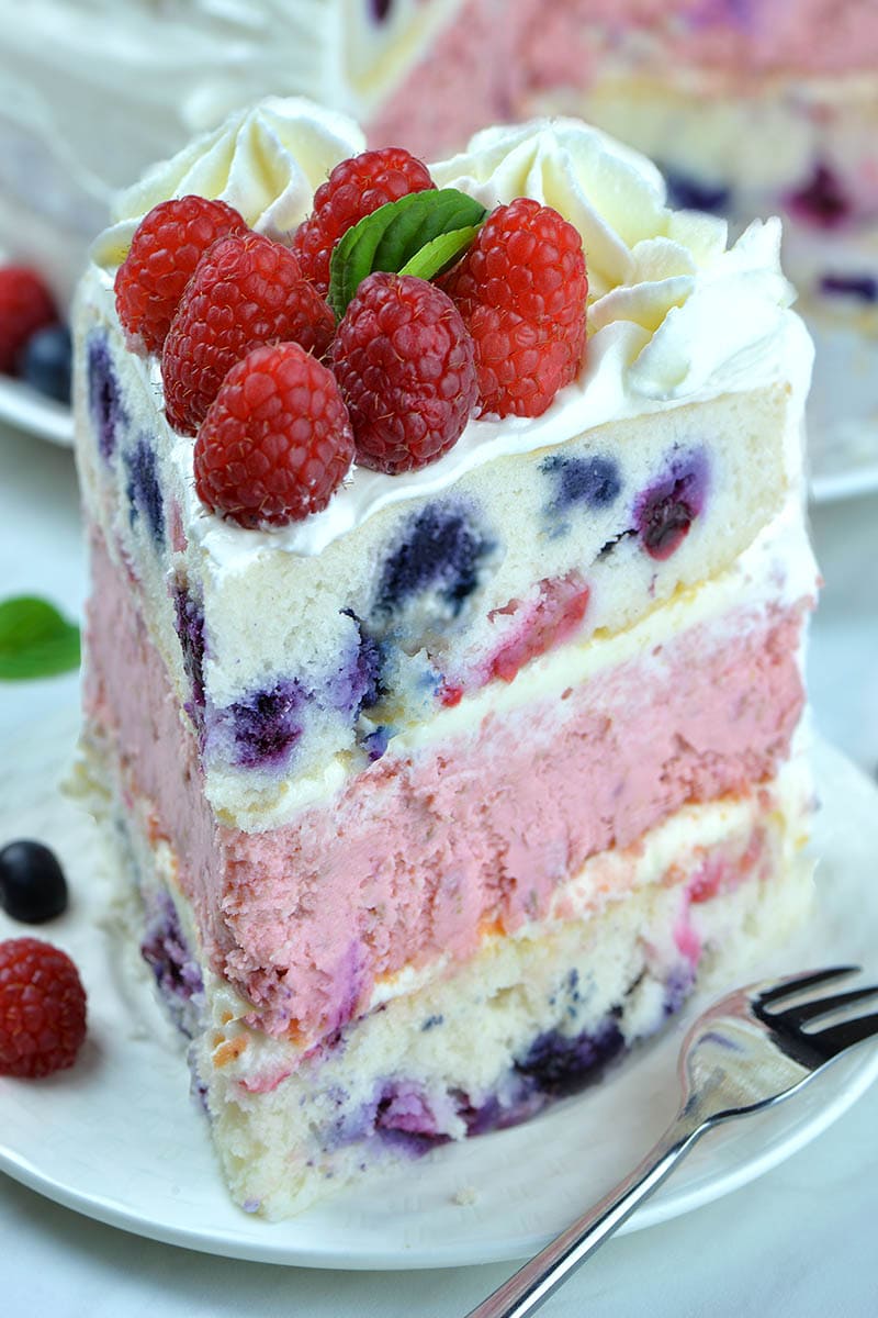 Vera | OMGChocolateRaspberry Cheesecake Cake - If you are looking for delicious red, white and blue dessert for 4th of July, this cake would be perfect! #raspberry #cheesecakerecipes #4thofjulyideas #cakerecipes