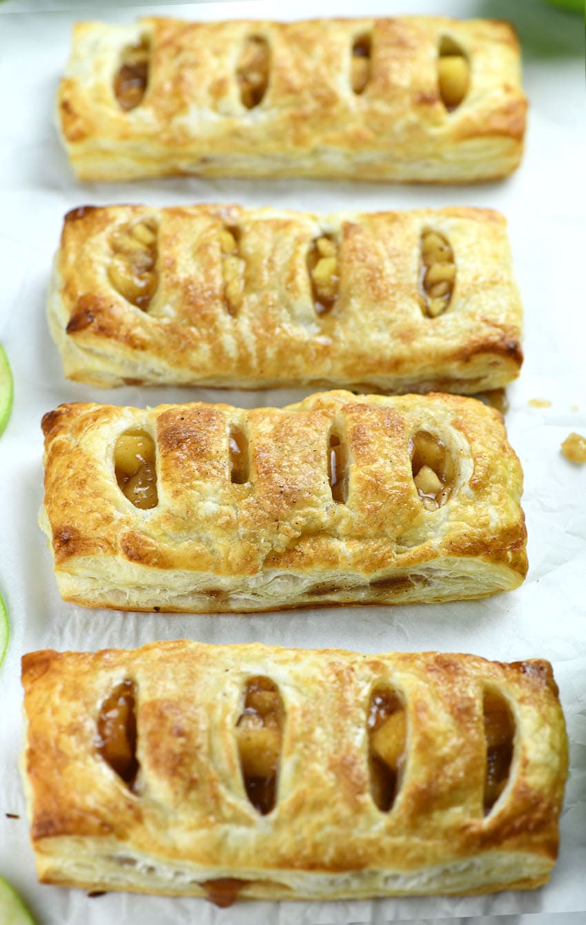 Four pieces of Copycat McDonald’s Apple Pies on parchment paper.