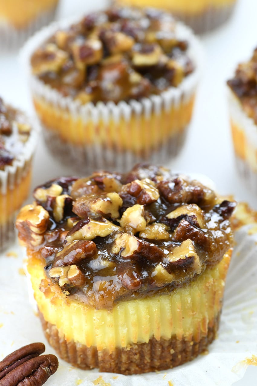 Mini Pecan Pie Cheesecakes on white paper.