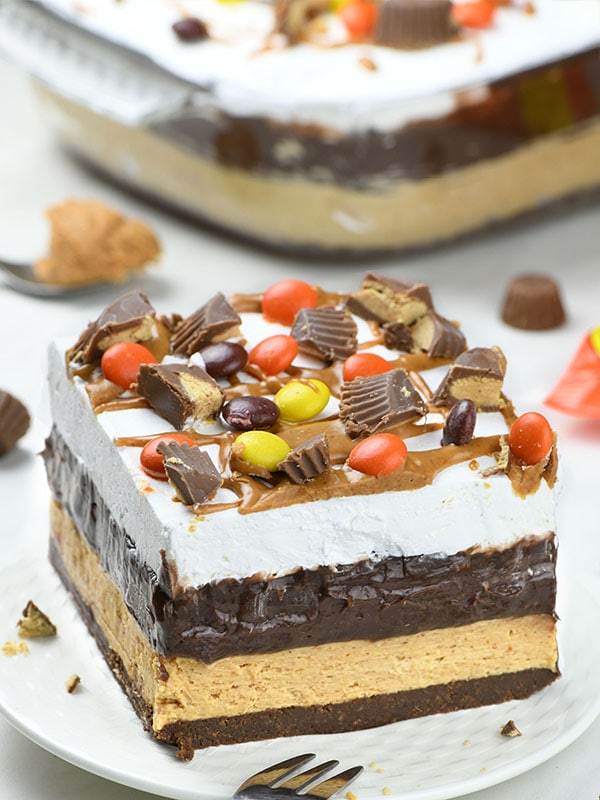 Chocolate Peanut Butter Lasagna on white plate garnished with Reese's Peanut Butter cups.