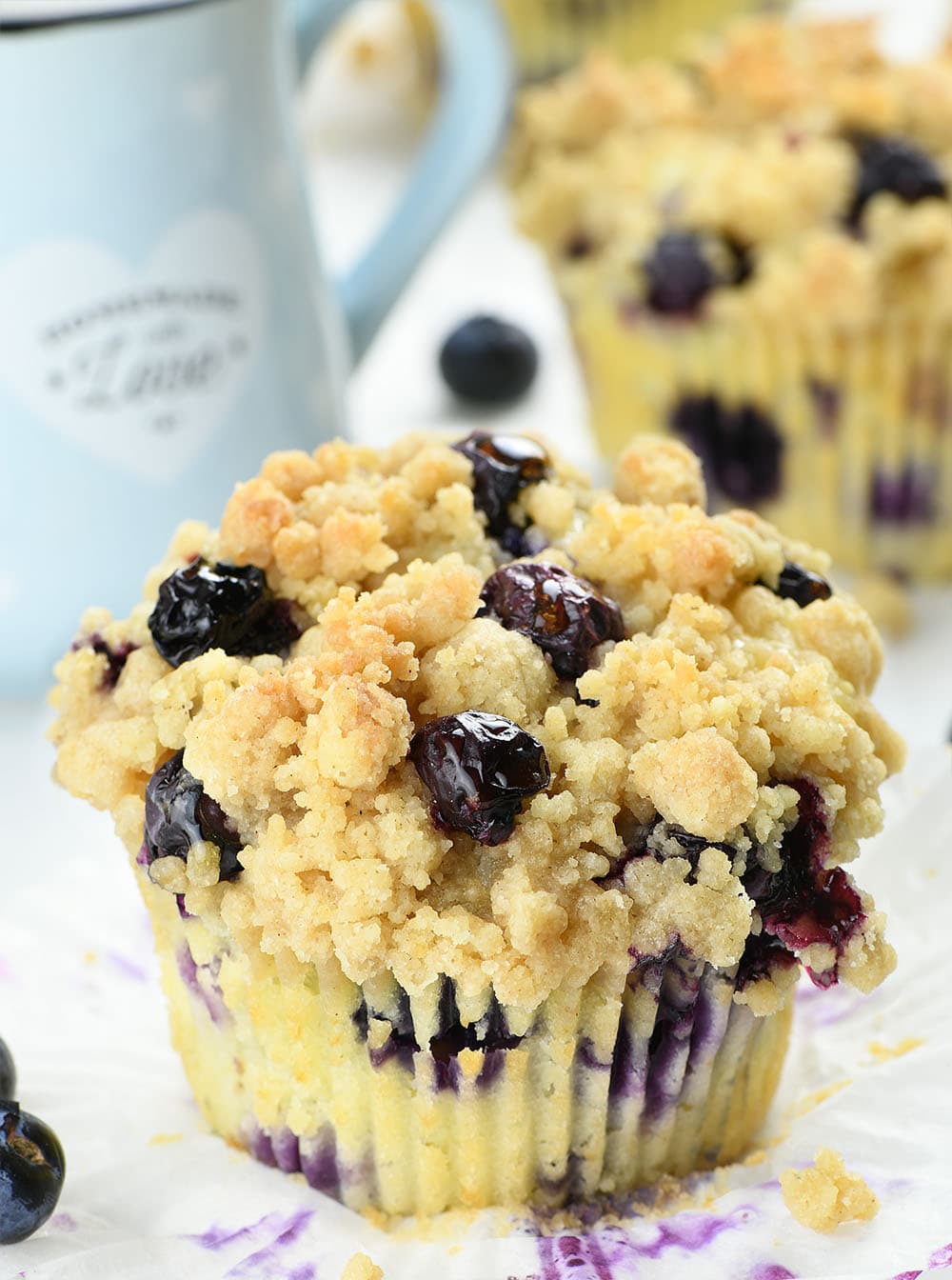 Blueberry Cream Cheese Muffins in front of couple of muffins.