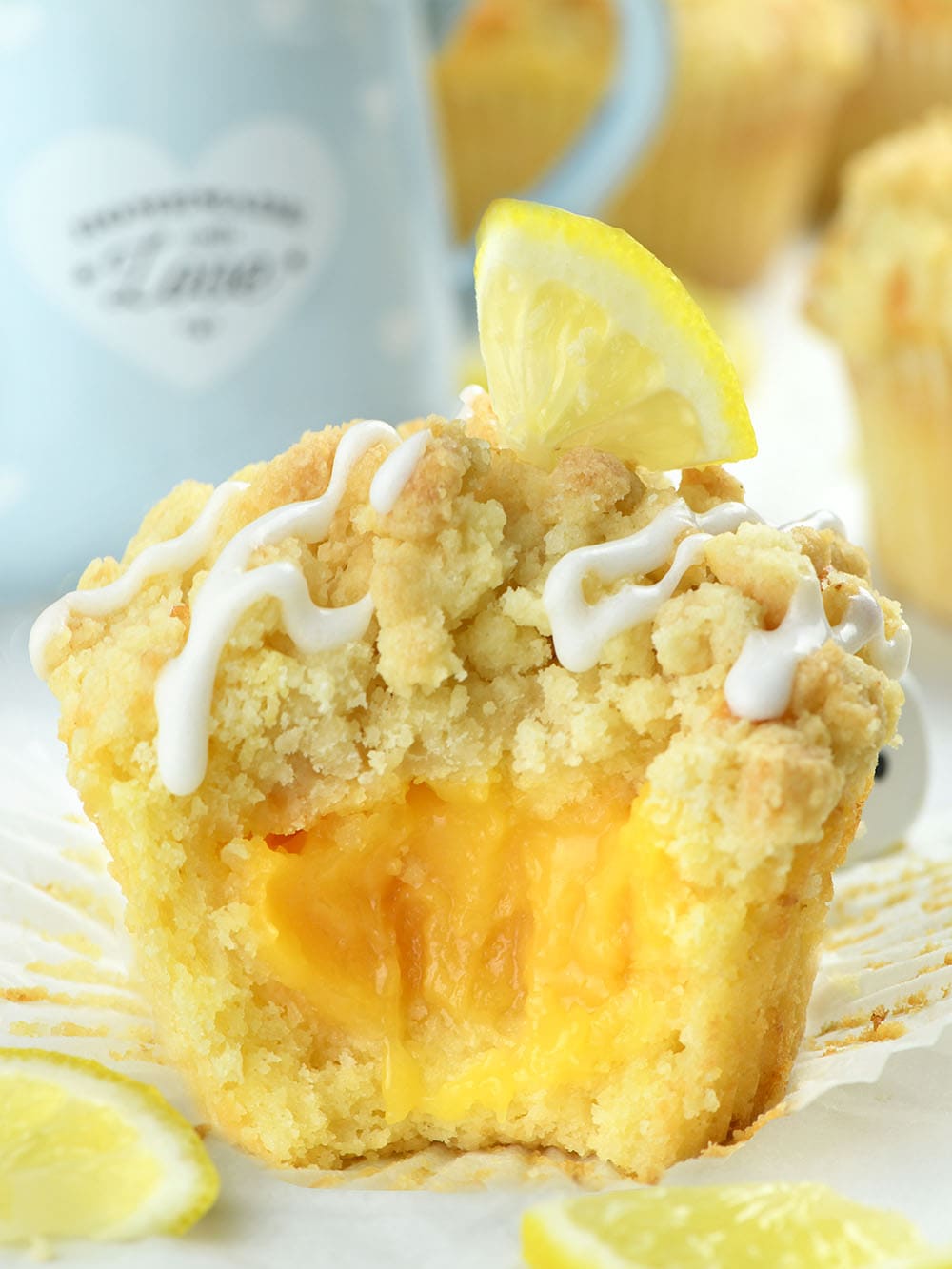 Lemon Curd Muffins with streusel crumb topping, drizzled with sweet glaze are generously filled with homemade lemon curd.