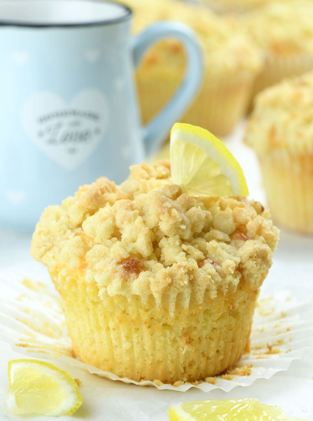Lemon Curd Muffins with streusel crumb topping, drizzled with sweet glaze.