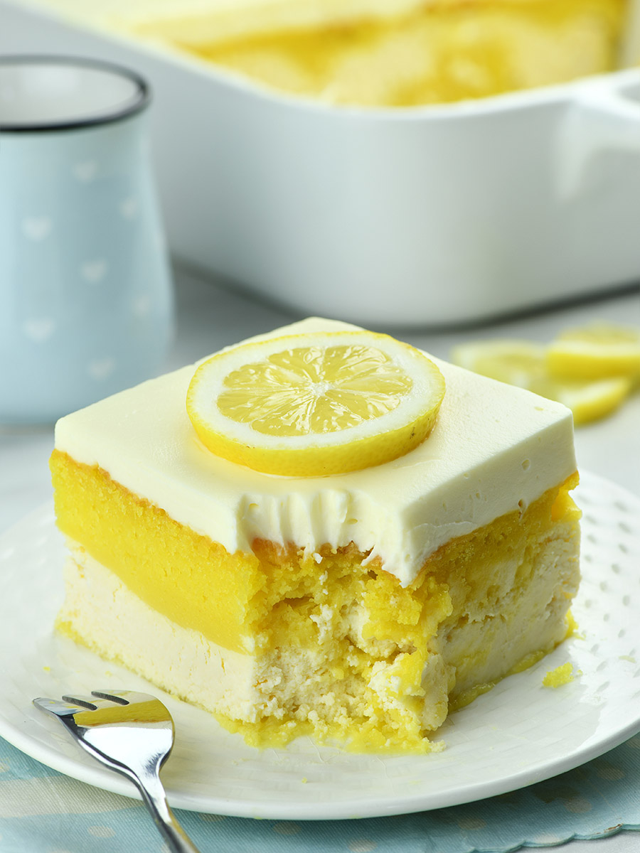 Lemon Love Cake garnished with lemon cream cheese frosting and lemon slice.