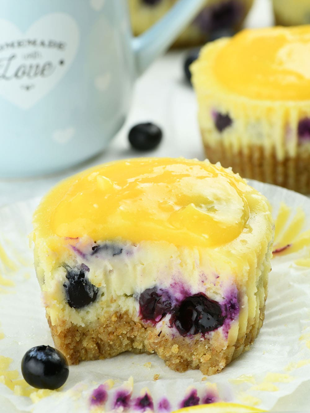 Bitten Mini Lemon Blueberry Cheesecakes with Lemon Curd .