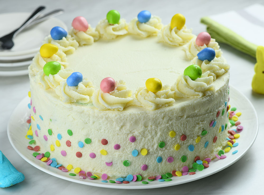 Cake with decorative pastel colors and Easter candies.