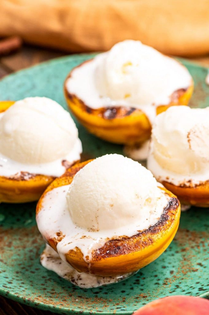 Juicy, delicious grilled peaches are an easy dessert to make on the grill. Simply brush them with oil, grill until they are tender and top with cinnamon, honey and a scoop of ice cream. The perfect summer dessert!