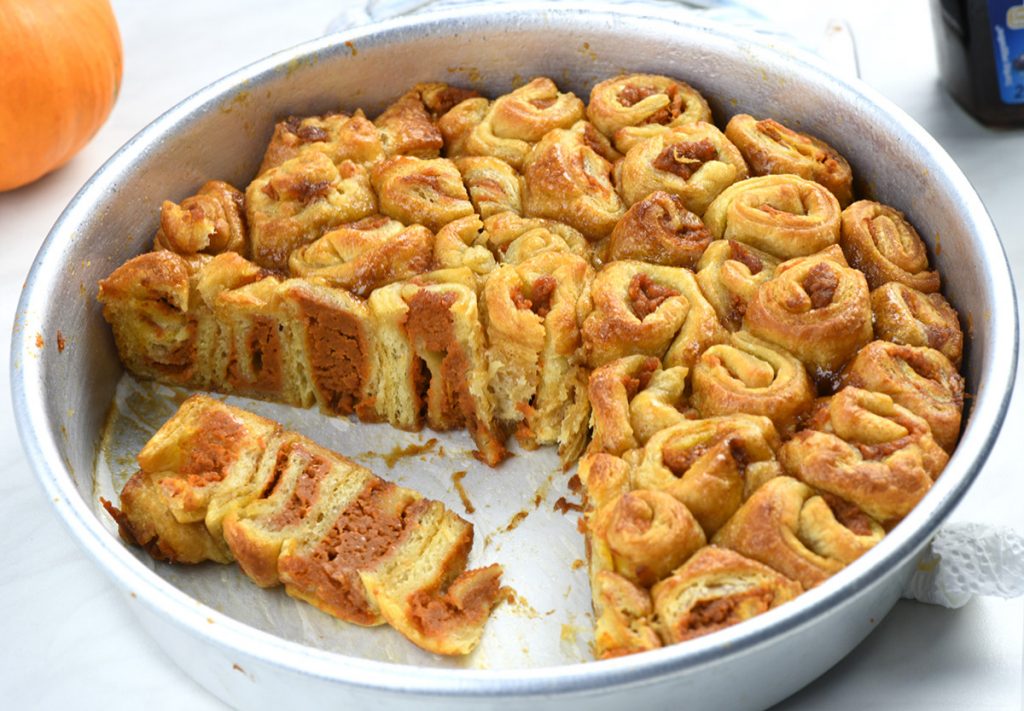  Pumpkin Crescent Roll-Up Bake in a baking dish with a piece removed.