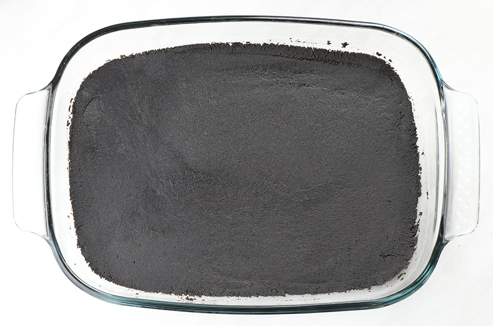 Oreo crust layer in a pan.