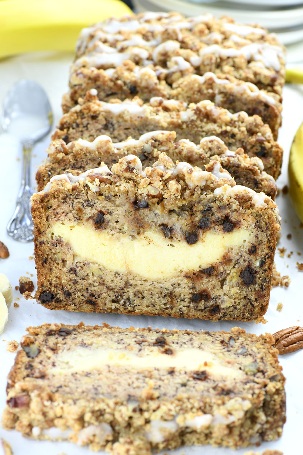 This banana bread stuffed with cream cheese filling, chocolate chips, and pecans with irresistible cinnamon streusel is more like delicious banana coffee cake, just baked in a loaf pan.