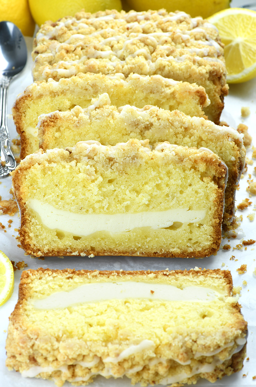 Lemon Pound Cake with cream cheese filling couple of slices on white paper.