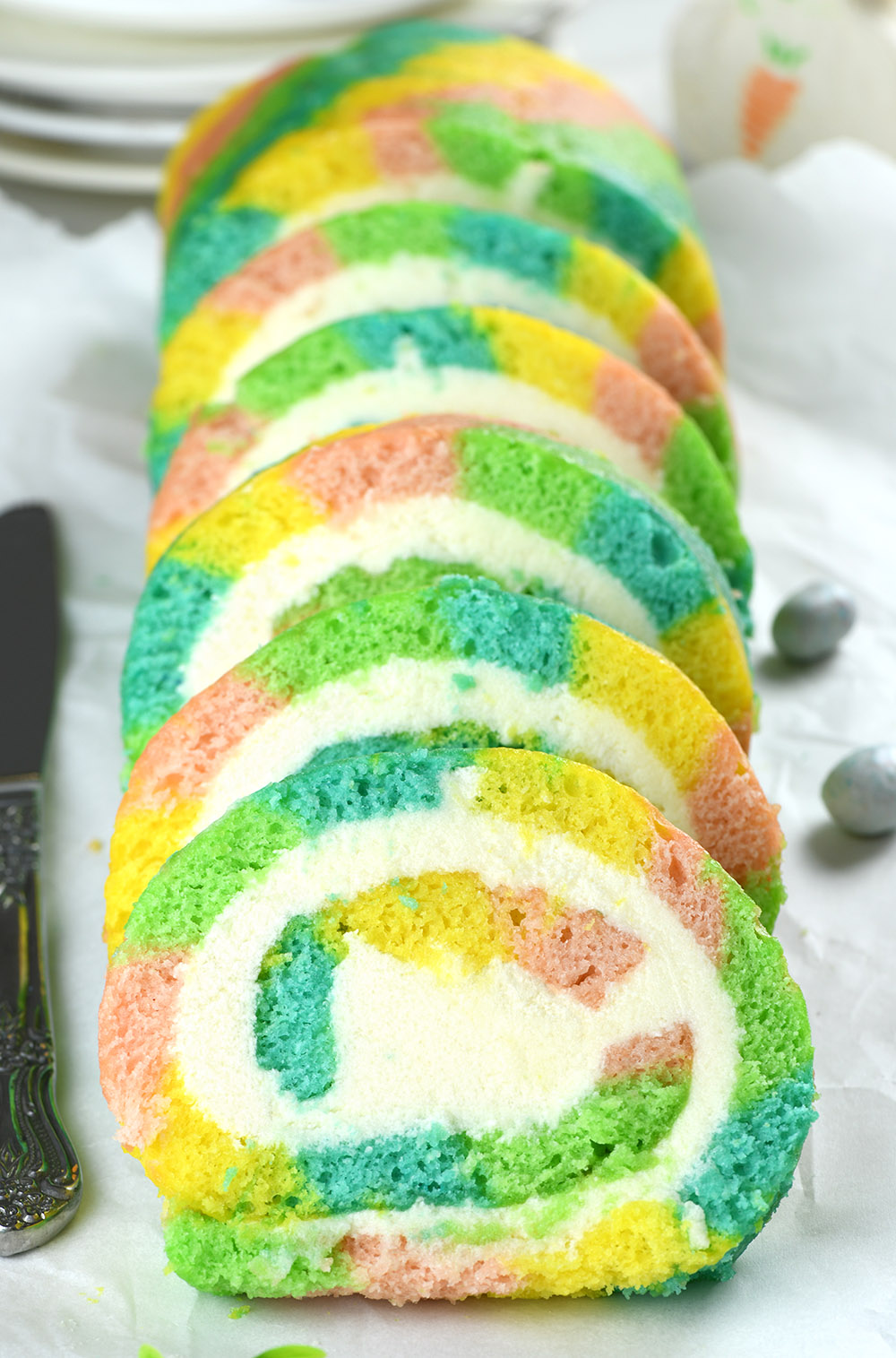 Multicolored Easter roll cake cut into several pieces