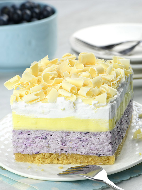 Blueberry Lemon Lasagna is layered dessert with tart lemon, sweet blueberries, goodness of cream cheese, Golden Oreo cookies, and white chocolate curls is irresistible combo.