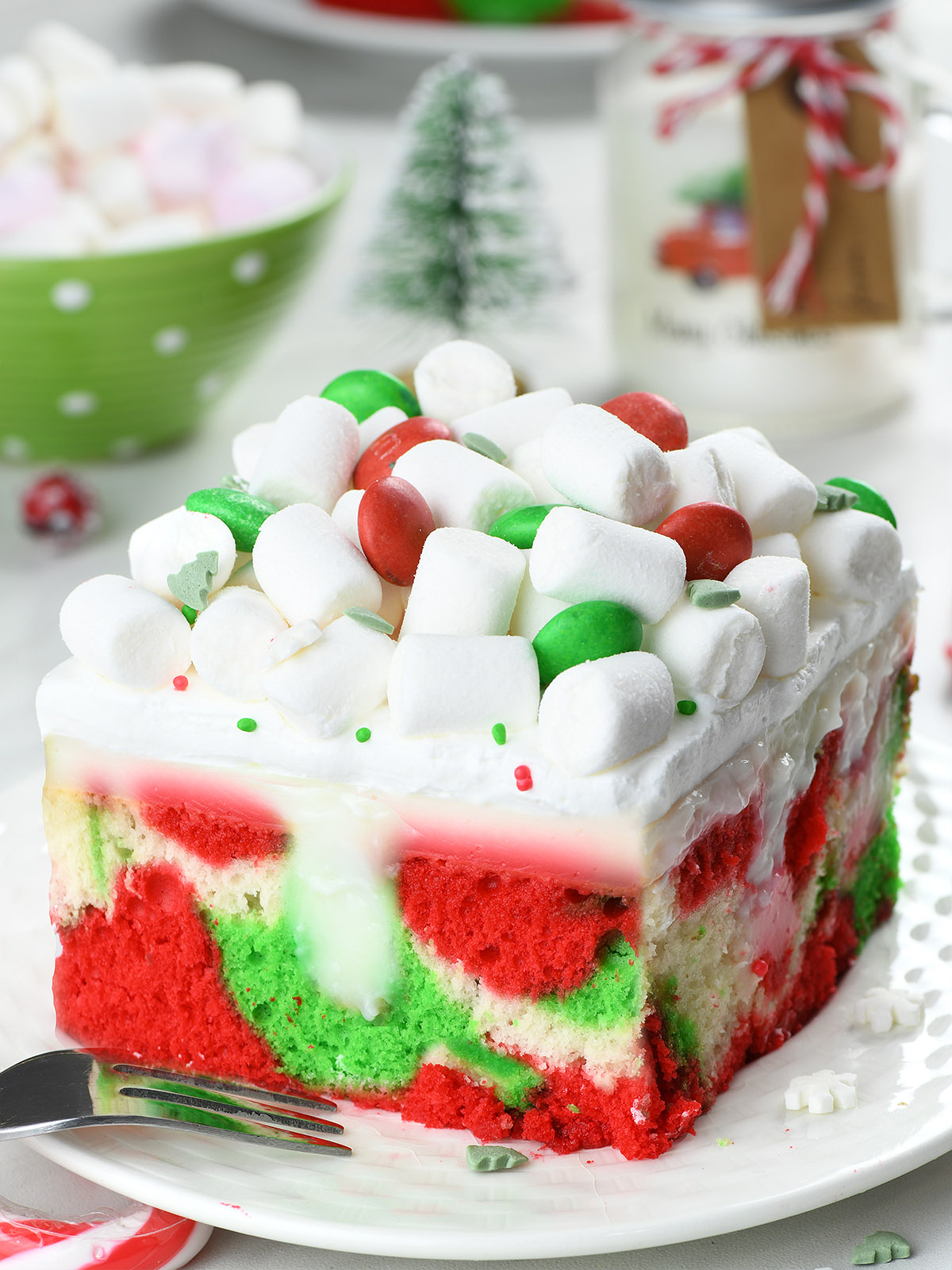 This festive Christmas Cake requires just a few simple ingredients: cake mix, instant pudding, whipped cream, and with a help of food coloring, it turns into a fun, and magical poke cake. 