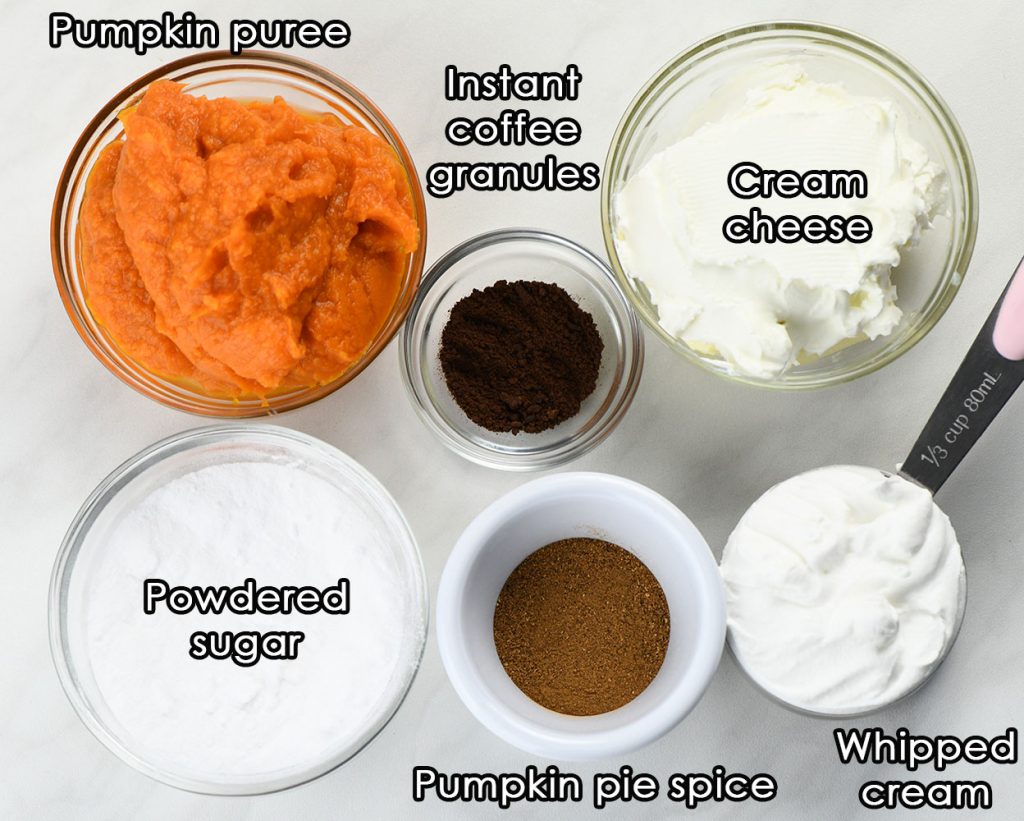 Ingredients for pumpkin spice latte mousse: pumpkin puree, cream cheese, instant coffee granules, powdered sugar, pumpkin pie spice, and whipped cream, each labeled in separate bowls.