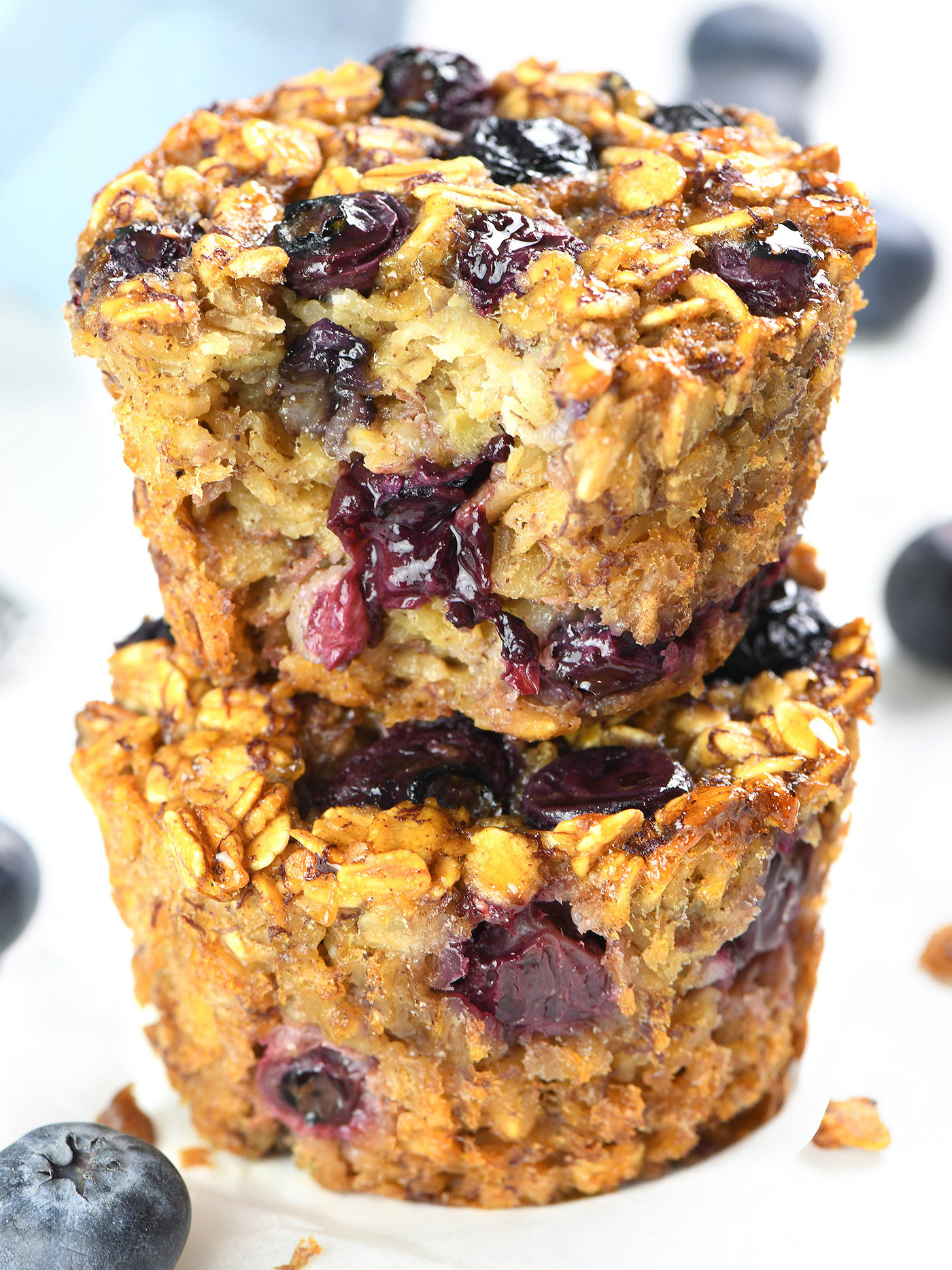 Stacked Blueberry Banana Baked Oatmeal Cups showing the moist interior filled with blueberries and oats.