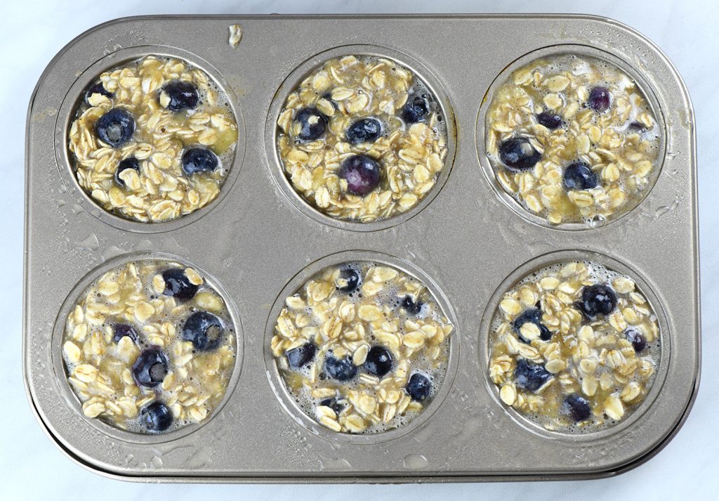 Close-up comparison of Blueberry Banana Baked Oatmeal before and after baking in a muffin tin.