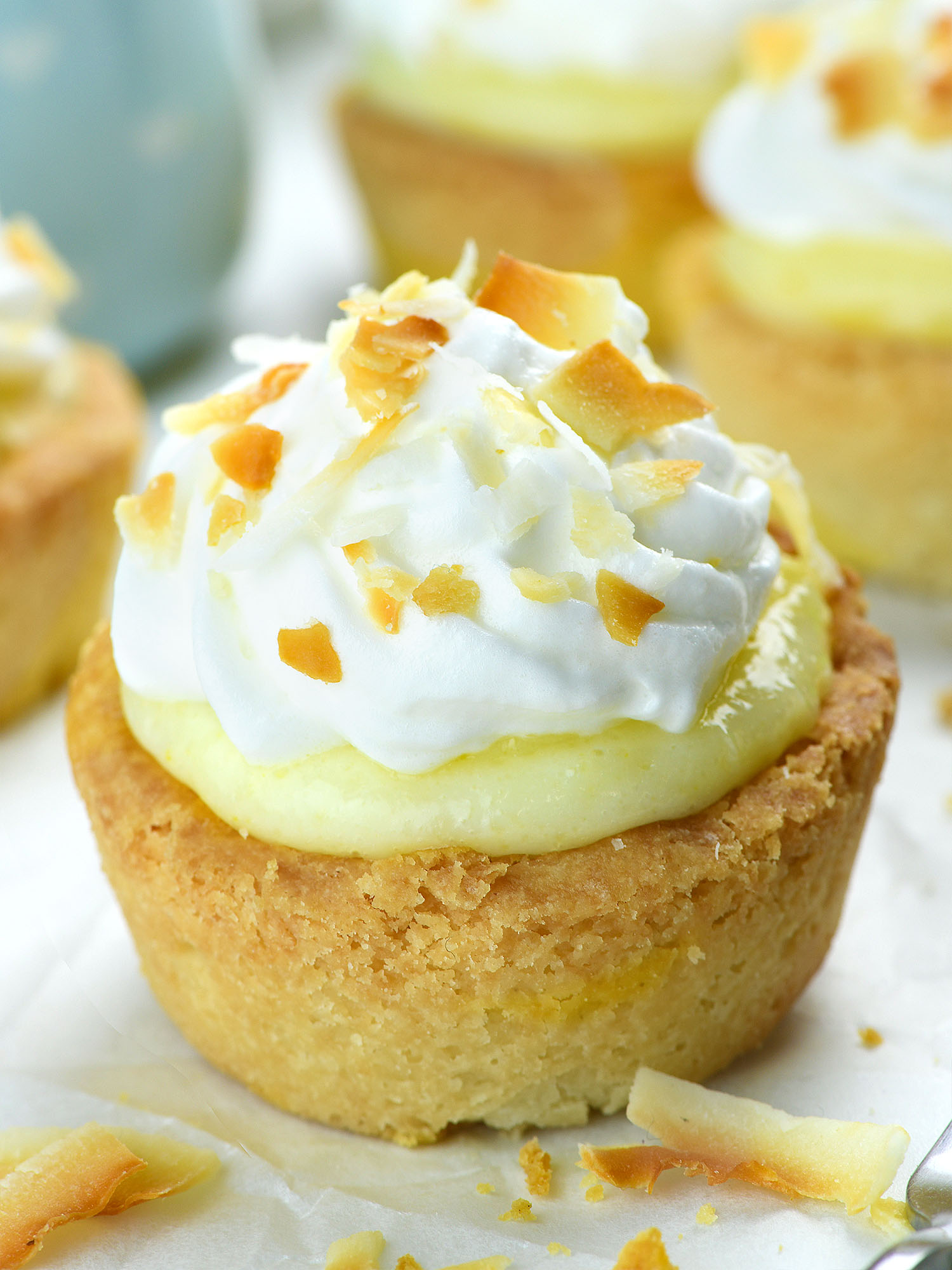 Coconut Cream Pie Cookie Cup topped with whipped cream and toasted coconut flakes.